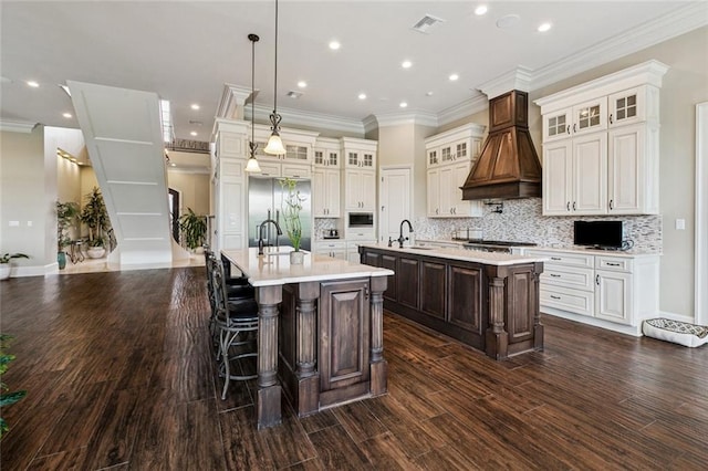 24 Royal Palm Dr, Kenner, LA 70065 - kitchen with a spacious island, light countertops, tasteful backsplash, crown molding, and built in appliances