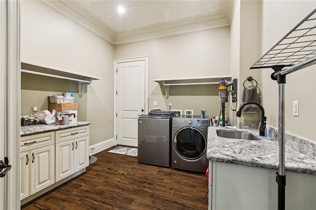 24 Royal Palm Dr, Kenner, LA 70065 - washroom featuring separate washer and dryer, crown molding, dark wood finished floors, and cabinet space