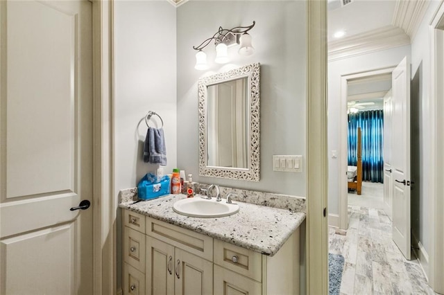 24 Royal Palm Dr, Kenner, LA 70065 - bathroom featuring crown molding, vanity, and wood finished floors