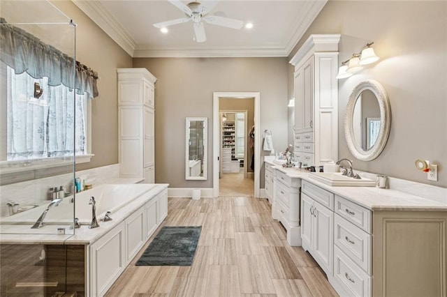 24 Royal Palm Dr, Kenner, LA 70065 - bathroom featuring a ceiling fan, vanity, a garden tub, crown molding, and recessed lighting