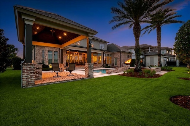 24 Royal Palm Dr, Kenner, LA 70065 - back of house featuring a patio, a yard, brick siding, and an outdoor pool