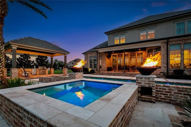 24 Royal Palm Dr, Kenner, LA 70065 - swimming pool featuring a gazebo, a fireplace, an in-ground hot tub, and a patio