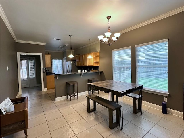146 Emerald Oaks Dr, Covington, LA 70433 - dining room with a chandelier, light tile patterned floors, and ornamental molding