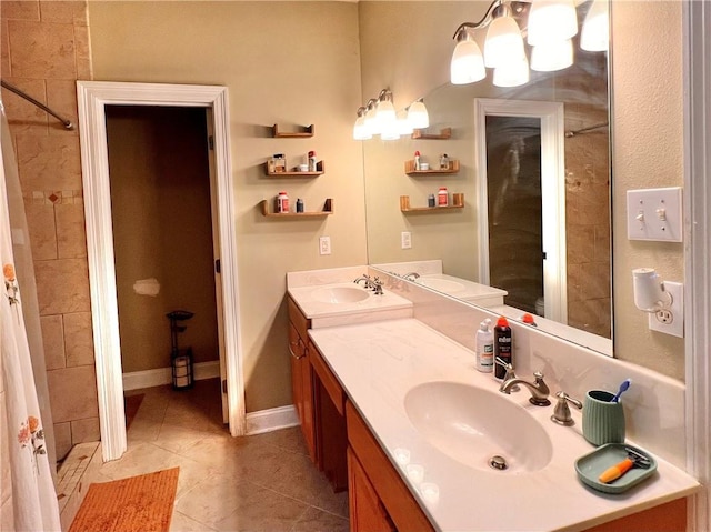 146 Emerald Oaks Dr, Covington, LA 70433 - bathroom featuring double vanity, a tile shower, tile patterned flooring, and a chandelier