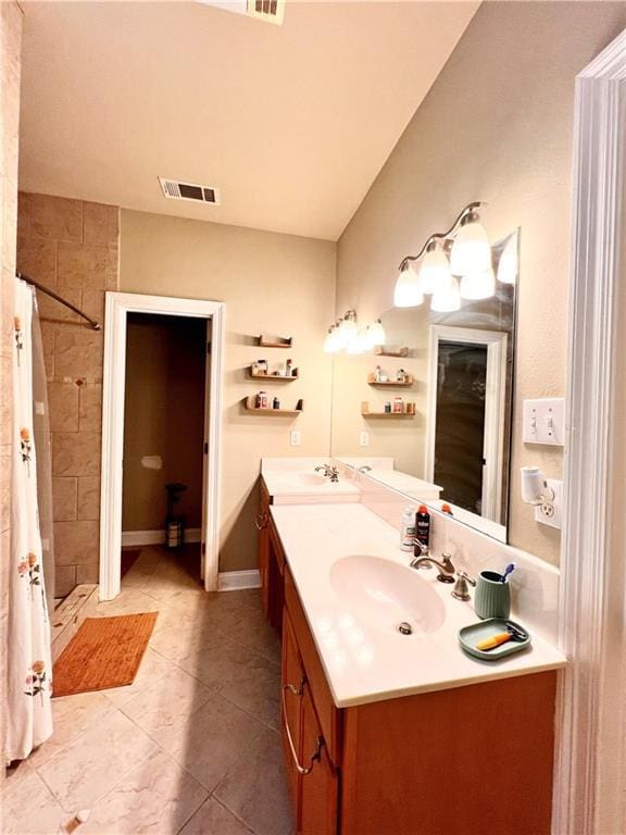 146 Emerald Oaks Dr, Covington, LA 70433 - bathroom with double vanity, a tile shower, and tile patterned flooring