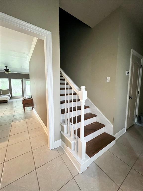146 Emerald Oaks Dr, Covington, LA 70433 - stairs with tile patterned floors, ornamental molding, and ceiling fan