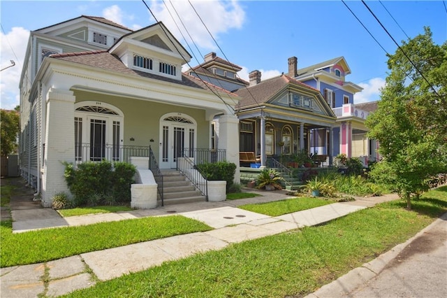 20810 S Scott St, New Orleans, LA 70119 - view of front of home featuring a porch and a front lawn