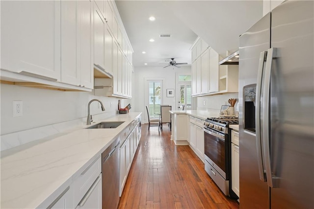 20810 S Scott St, New Orleans, LA 70119 - kitchen featuring appliances with stainless steel finishes, recessed lighting, ceiling fan, dark wood finished floors, and white cabinets