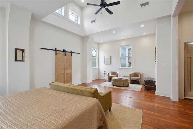 20810 S Scott St, New Orleans, LA 70119 - bedroom with a barn door, wood finished floors, recessed lighting, a towering ceiling, and a ceiling fan