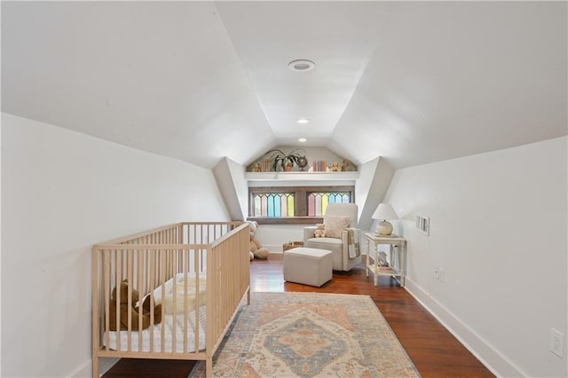 20810 S Scott St, New Orleans, LA 70119 - bedroom with vaulted ceiling, wood finished floors, and a nursery area
