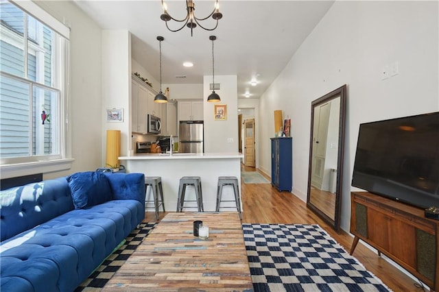 20810 S Scott St, New Orleans, LA 70119 - living room featuring light wood-style floors and a chandelier