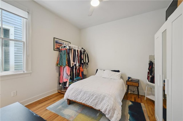 20810 S Scott St, New Orleans, LA 70119 - bedroom featuring multiple windows, wood finished floors, and a ceiling fan