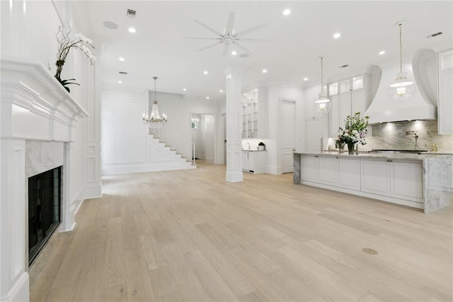 108 Dorrington Blvd, Metairie, LA 70005 - unfurnished living room featuring light wood-type flooring, ceiling fan, a fireplace, recessed lighting, and stairway