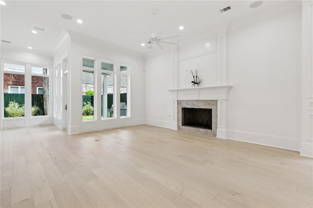 108 Dorrington Blvd, Metairie, LA 70005 - unfurnished living room featuring a premium fireplace, crown molding, healthy amount of natural light, light wood-style flooring, and ceiling fan