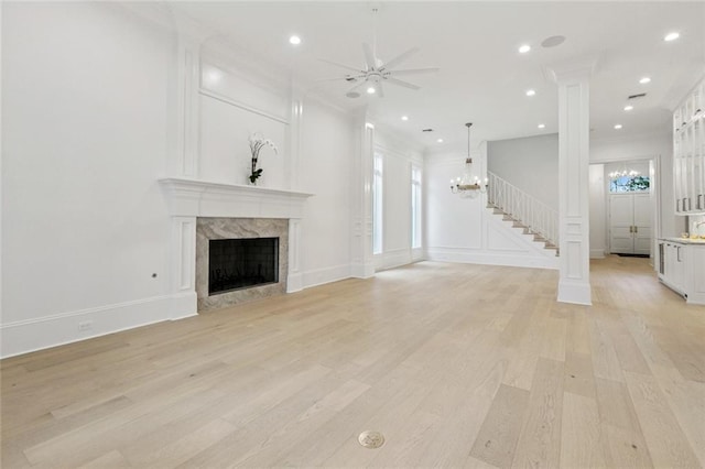 108 Dorrington Blvd, Metairie, LA 70005 - unfurnished living room featuring a chandelier, ceiling fan, light wood-type flooring, a decorative wall, and recessed lighting