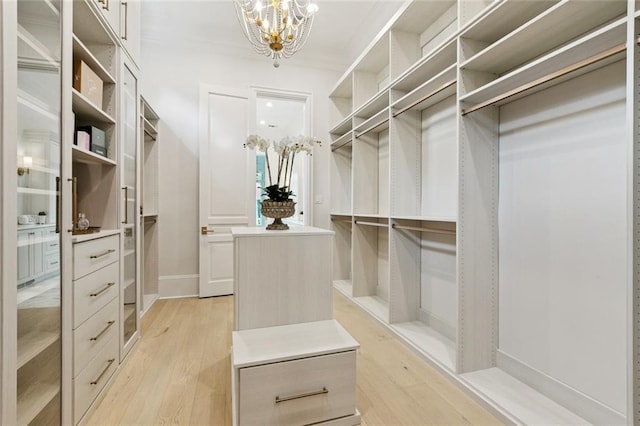108 Dorrington Blvd, Metairie, LA 70005 - walk in closet featuring light wood-style floors and a chandelier