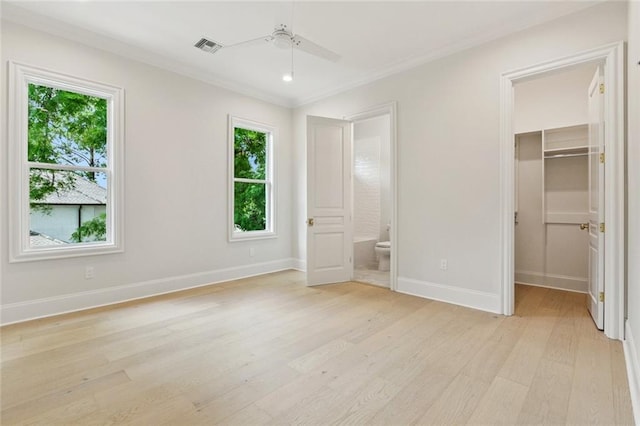 108 Dorrington Blvd, Metairie, LA 70005 - unfurnished bedroom with a walk in closet, light wood-type flooring, crown molding, a closet, and connected bathroom