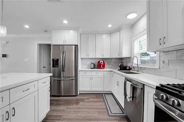 813 Cynthia Ave, Metairie, LA 70003 - kitchen with appliances with stainless steel finishes, light countertops, white cabinetry, recessed lighting, and decorative backsplash