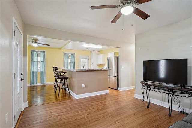 3713 Lausat St, Metairie, LA 70001 - living room featuring light wood-style floors and a ceiling fan