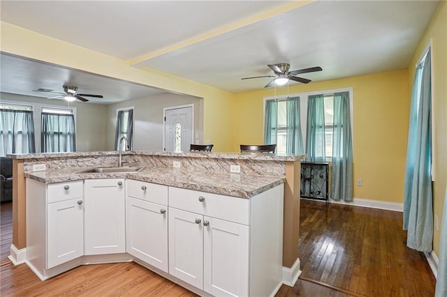 3713 Lausat St, Metairie, LA 70001 - kitchen with a ceiling fan, light wood-style flooring, light stone countertops, and white cabinets