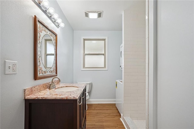 3713 Lausat St, Metairie, LA 70001 - bathroom with vanity, tiled shower, wood finished floors, and washer / clothes dryer