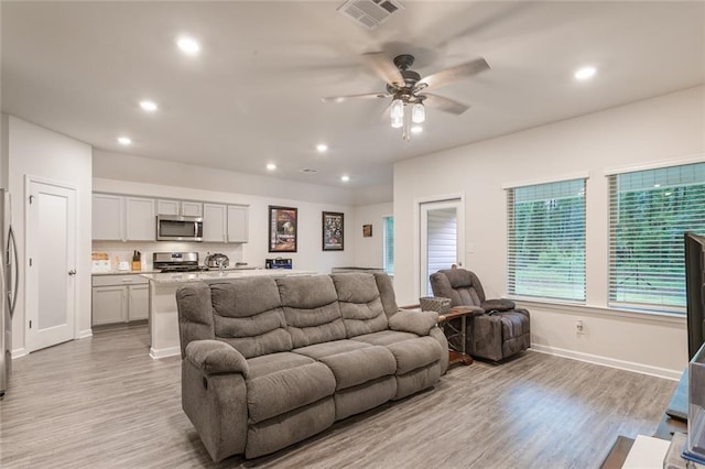 28399 Longfellow Ln, Albany, LA 70711 - living area featuring light wood-style floors, ceiling fan, and recessed lighting