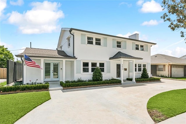 4625 Cleveland Pl, Metairie, LA 70003 - view of front facade with french doors, a chimney, and driveway