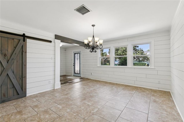 4625 Cleveland Pl, Metairie, LA 70003 - unfurnished dining area with a barn door, a chandelier, and wood walls