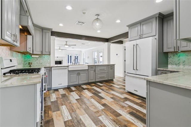4625 Cleveland Pl, Metairie, LA 70003 - kitchen featuring gray cabinetry, white appliances, a peninsula, light wood-type flooring, and a ceiling fan