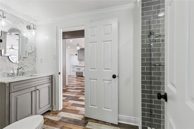 4625 Cleveland Pl, Metairie, LA 70003 - full bath with vanity, wood finished floors, ornamental molding, backsplash, and a tile shower