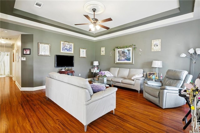 4501 13th St, Marrero, LA 70072 - living room featuring a raised ceiling, ceiling fan, and wood finished floors