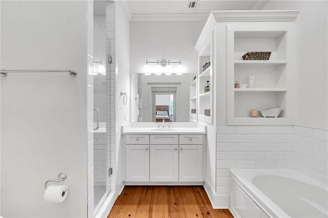 436 S Cortez St, New Orleans, LA 70119 - bathroom featuring a shower stall, crown molding, a bath, vanity, and wood finished floors