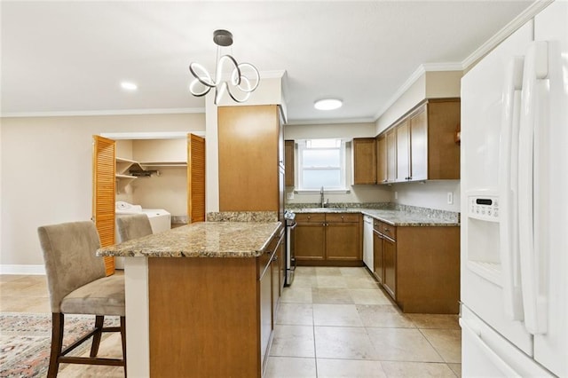 4513 Dreyfous Ave, Metairie, LA 70006 - kitchen featuring white appliances, a peninsula, crown molding, a kitchen bar, and brown cabinetry