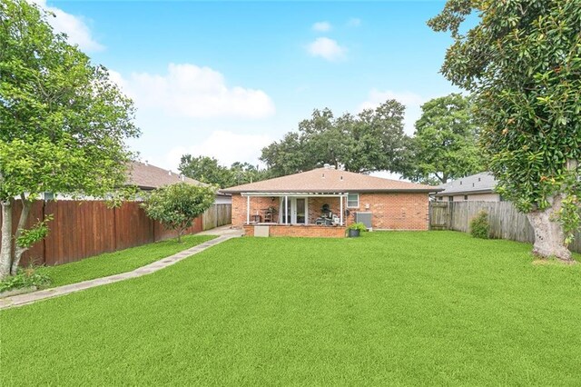4513 Dreyfous Ave, Metairie, LA 70006 - rear view of property featuring brick siding, a fenced backyard, and a patio area