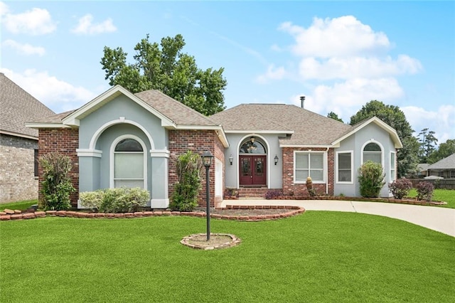 314 Spartan Loop, Slidell, LA 70458 - ranch-style home featuring a front lawn, a shingled roof, french doors, and brick siding