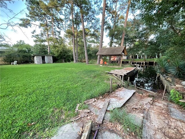 2986 Palm Dr, Slidell, LA 70458 - view of green lawn with a shed