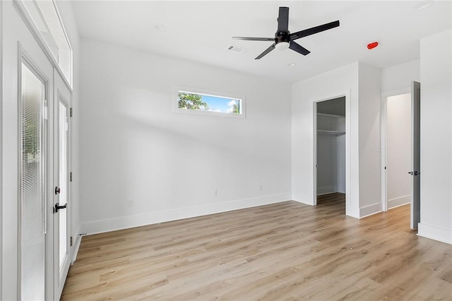 1871 N Roman St, New Orleans, LA 70116 - unfurnished bedroom with light wood finished floors, a ceiling fan, and a walk in closet
