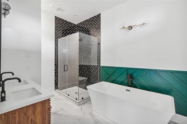 1871 N Roman St, New Orleans, LA 70116 - bathroom with marble finish flooring, a soaking tub, a stall shower, double vanity, and a wainscoted wall