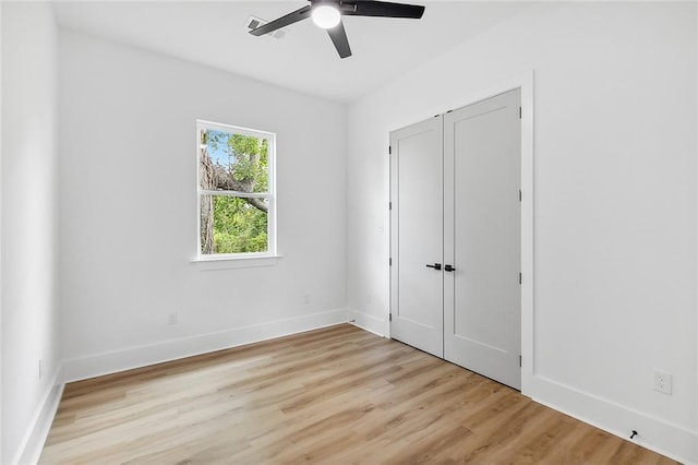 1871 N Roman St, New Orleans, LA 70116 - unfurnished bedroom with light wood finished floors and a ceiling fan