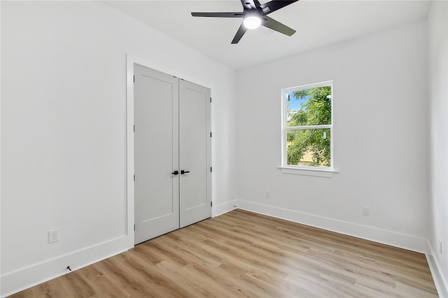 1871 N Roman St, New Orleans, LA 70116 - unfurnished bedroom featuring light wood finished floors, a closet, and a ceiling fan
