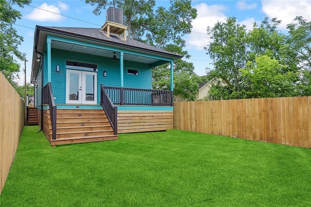1871 N Roman St, New Orleans, LA 70116 - back of property with a fenced backyard, stairway, and roof with shingles