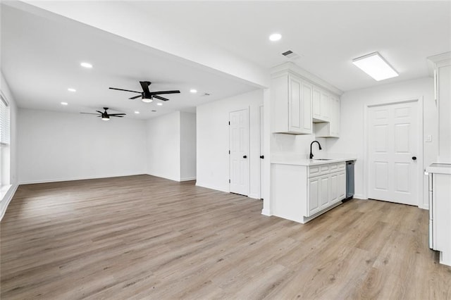 1828 San Francisco Rd, La Place, LA 70068 - kitchen featuring light countertops, stainless steel dishwasher, white cabinetry, and recessed lighting