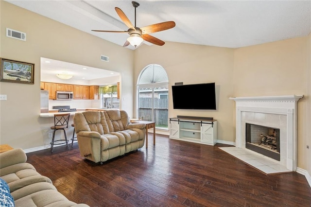 416 Spartan Loop, Slidell, LA 70458 - living area with ceiling fan, hardwood / wood-style flooring, vaulted ceiling, and a tiled fireplace