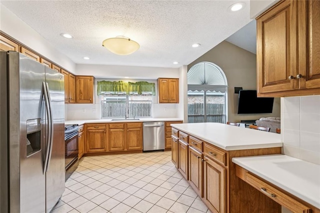 416 Spartan Loop, Slidell, LA 70458 - kitchen with appliances with stainless steel finishes, light countertops, brown cabinets, a textured ceiling, and recessed lighting