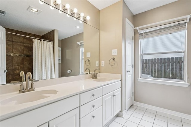 416 Spartan Loop, Slidell, LA 70458 - full bathroom featuring double vanity, tile patterned flooring, and a tile shower