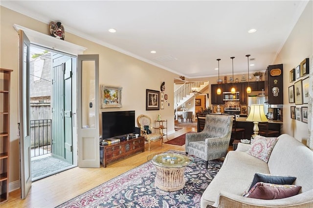 626 Independence St, New Orleans, LA 70117 - living room with stairs, light wood-type flooring, ornamental molding, and recessed lighting