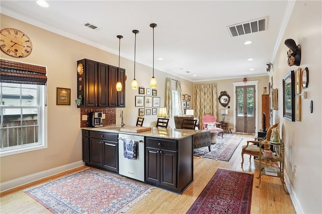 626 Independence St, New Orleans, LA 70117 - kitchen featuring dishwasher, a peninsula, light wood-type flooring, ornamental molding, and dark brown cabinetry
