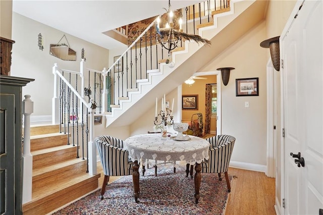 626 Independence St, New Orleans, LA 70117 - dining space featuring stairway, wood finished floors, and a chandelier