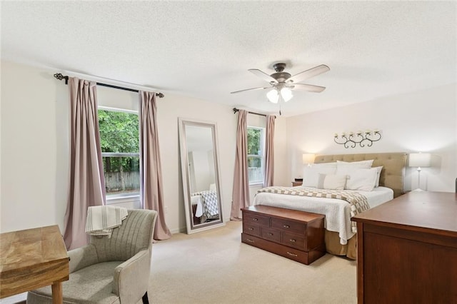 240 Emerald Crk W, Abita Springs, LA 70420 - bedroom featuring light carpet, a textured ceiling, and a ceiling fan