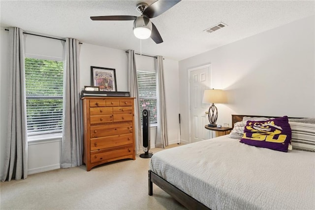 240 Emerald Crk W, Abita Springs, LA 70420 - bedroom featuring a textured ceiling, a ceiling fan, and light colored carpet